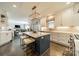 Bright kitchen with stainless steel appliances, white cabinets, and a beautiful blue island with countertop seating at 8902 Whittingham Dr, Waxhaw, NC 28173