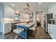 Spacious kitchen with stainless steel appliances, white cabinets, and island with marble countertop and bar stool seating at 8902 Whittingham Dr, Waxhaw, NC 28173