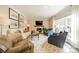 Cozy living room featuring a fireplace, neutral furniture, and large windows with natural light at 8902 Whittingham Dr, Waxhaw, NC 28173