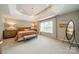 Elegant main bedroom with tray ceilings, ample natural light, and stylish furnishings at 8902 Whittingham Dr, Waxhaw, NC 28173