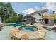 Gorgeous backyard oasis with a private pool, spa, patio, and outdoor seating area at 8902 Whittingham Dr, Waxhaw, NC 28173