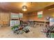 Spacious garage area features wood paneled walls, shelving, and work tables at 8903 Larchmont Cir, Charlotte, NC 28214