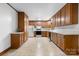 Spacious kitchen with ample wood cabinets, white appliances and neutral flooring, ready for cooking at 8903 Larchmont Cir, Charlotte, NC 28214