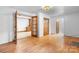 Open-concept living room showcasing hardwood floors and traditional design elements at 8903 Larchmont Cir, Charlotte, NC 28214