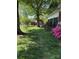Landscaped backyard featuring red storage sheds and mature trees, perfect for outdoor activities at 918 Carmel Dr, Gastonia, NC 28056