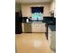 The kitchen has a window over the sink, white cabinets and black appliances at 918 Carmel Dr, Gastonia, NC 28056