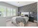 Bedroom with a monochrome color palette and a decorative accent wall at 924 Forbes Rd, Fort Mill, SC 29707