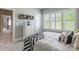 Cozy bedroom featuring neutral walls, white trim, and bright windows with plantation shutters at 924 Forbes Rd, Fort Mill, SC 29707