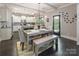 The dining room, open to the kitchen, features modern lighting, a dining table with bench seating, and access to the outdoors at 924 Forbes Rd, Fort Mill, SC 29707
