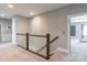 Upstairs hallway with decorative accent wall and carpet flooring leading to bedrooms at 924 Forbes Rd, Fort Mill, SC 29707