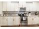 A modern kitchen with white cabinets, stainless steel appliances, and granite countertops is well-equipped for cooking at 924 Forbes Rd, Fort Mill, SC 29707
