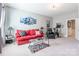 Comfortable living room with red sofa, arm chair, and decor at 924 Forbes Rd, Fort Mill, SC 29707