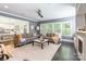 Cozy living room featuring a large window, comfortable seating, and views into the modern kitchen provides an inviting space at 924 Forbes Rd, Fort Mill, SC 29707