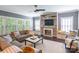 Bright living room with fireplace, built-in shelving, and comfortable seating offers a welcoming space for relaxation and entertainment at 924 Forbes Rd, Fort Mill, SC 29707