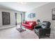 Stylish living room with red sofa and a black leather chair and neutral color scheme at 924 Forbes Rd, Fort Mill, SC 29707