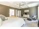 Bright main bedroom boasting a tray ceiling, neutral decor, and ample space with a luxurious aesthetic at 924 Forbes Rd, Fort Mill, SC 29707