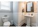 Charming powder room featuring elegant pedestal sink and decorative tiled accent wall at 924 Forbes Rd, Fort Mill, SC 29707