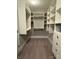 Walk-in closet featuring custom shelving, hanging rods, and drawer units for organized storage at 924 Forbes Rd, Fort Mill, SC 29707