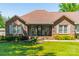 Beautiful home featuring brick facade, well-kept lawn, and vibrant flowerbeds at 1005 Spring Rock Dr, Salisbury, NC 28146