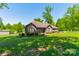 Beautiful brick home with a large yard, lush lawn and mature trees at 1005 Spring Rock Dr, Salisbury, NC 28146