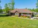 Charming brick home featuring a well-manicured lawn and colorful landscaping at 1005 Spring Rock Dr, Salisbury, NC 28146