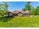 Charming brick home with mature landscaping and a sprawling green lawn at 1005 Spring Rock Dr, Salisbury, NC 28146