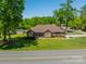 Inviting brick home with a lush green lawn and mature trees at 1005 Spring Rock Dr, Salisbury, NC 28146
