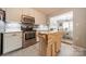 Well-appointed kitchen with stainless steel appliances and an island featuring a butcher block top at 1005 Spring Rock Dr, Salisbury, NC 28146