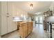 Spacious kitchen featuring an island, white cabinets and modern lighting with french doors leading to deck at 1005 Spring Rock Dr, Salisbury, NC 28146