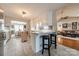Bright kitchen features white cabinetry, granite countertops, and a seating area leading to living room at 1005 Spring Rock Dr, Salisbury, NC 28146