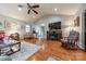 Inviting living room with hardwood floors, a cozy fireplace, and a view of the adjoining kitchen at 1005 Spring Rock Dr, Salisbury, NC 28146
