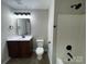 Bathroom featuring vanity with sleek fixtures, white countertop, toilet and shower with black shower head at 113 Burke Cir, Mooresville, NC 28115