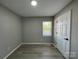 This bedroom features neutral walls, wood look floors and a window with blinds at 113 Burke Cir, Mooresville, NC 28115