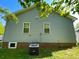 Home exterior showing blue siding, brick foundation, air conditioning unit, blue sky, and green trees at 113 Burke Cir, Mooresville, NC 28115