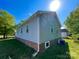 Home exterior showing blue siding, brick foundation, manicured lawn, blue sky, and green trees at 113 Burke Cir, Mooresville, NC 28115