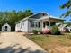 Charming one-story home with light gray siding, an inviting front porch, and lush landscaping at 113 Burke Cir, Mooresville, NC 28115