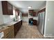 Open kitchen featuring stainless steel appliances, stylish backsplash, and dark wood cabinets at 113 Burke Cir, Mooresville, NC 28115