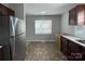 Kitchen with tile flooring, dark wood cabinets, stainless steel appliances, and bright natural lighting at 113 Burke Cir, Mooresville, NC 28115