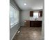 Bright kitchen with tile flooring, dark cabinets, stainless steel sink, and plenty of natural light at 113 Burke Cir, Mooresville, NC 28115