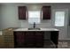 Kitchen with dark cabinets, granite countertops, subway tile backsplash, and stainless steel sink at 113 Burke Cir, Mooresville, NC 28115
