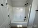 Shower featuring new fixtures, white tiled walls and black shower head at 113 Burke Cir, Mooresville, NC 28115