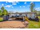 Wide shot of backyard with deck, shed, slide, and grassy area at 114 Doubletree Dr, Statesville, NC 28677