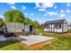 Backyard view featuring a patio area, an outdoor shed, and a well-maintained lawn, perfect for outdoor activities at 114 Doubletree Dr, Statesville, NC 28677