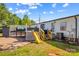 Backyard with deck, stairs, outdoor furniture, shed, and yellow slide at 114 Doubletree Dr, Statesville, NC 28677