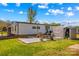 Backyard with concrete patio, outdoor seating, grass, and storage sheds at 114 Doubletree Dr, Statesville, NC 28677