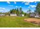 Expansive backyard with sheds, grassy lawn, and mature trees on a sunny day at 114 Doubletree Dr, Statesville, NC 28677