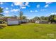 Expansive backyard featuring a shed, lush green grass, and a view of the house, ideal for outdoor enjoyment at 114 Doubletree Dr, Statesville, NC 28677