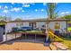 Backyard features a deck with seating, outdoor furniture, and a yellow slide at 114 Doubletree Dr, Statesville, NC 28677