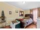 Bedroom featuring natural light, a patterned bedspread, and decorative animal prints at 114 Doubletree Dr, Statesville, NC 28677