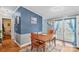 A charming dining room with a wooden table, cozy rug and blue accent wall at 114 Doubletree Dr, Statesville, NC 28677